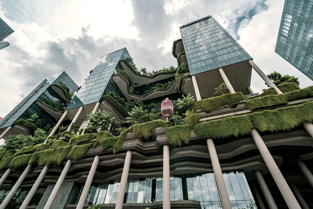 Glass towers rising from densely planted concrete terraces at the Parkroyal Collection Pickering in Singapore