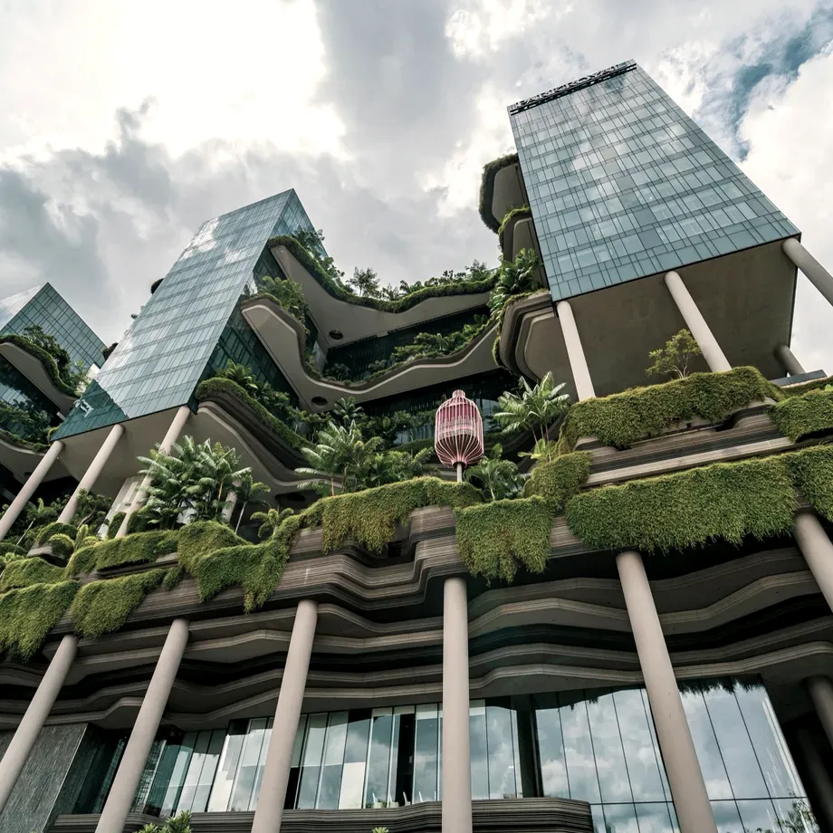 Glass towers rising from densely planted concrete terraces at the Parkroyal Collection Pickering in Singapore